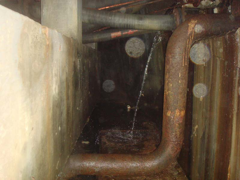 The wall of the power house dome just beneath the entrance showing some smaller piping and more water.