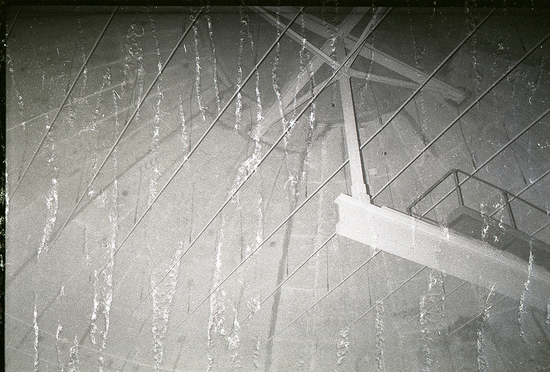 Unknown squadron and site undergoing salvage operations. Presumed to be taken in the early 1970's, this photo shows the central-pivot crane in the apex of the power house dome. Acoustic baffling has been removed as part of salvage operations leaving vacant hangers visible running across the scene. Note: photo negative appears to have water damage. Please contact me at chromehooves@hotmail.com if you have any information on this photo. Any help identifying this or any other photos in the archive is greatly appreciated. Taken: Unknown-- probably late 1960's to early 1970's. Source: provided courtesy of the Titan Missile Museum/Nick Halliday (http://www.titanmissilemuseum.org/) titan_1-1.jpg