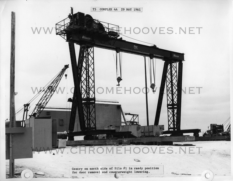 Construction at Beale 851-A, silo #1. An enormous gantry crane used to install the silo doors and launcher elevator counterweights. The weights can be seen laying on their sides under the gantry. Taken: May 29, 1961. Source: Martin Co. titan_group012-1.jpg