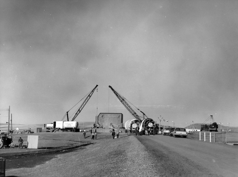 Missile installation at Ellsworth 850-A, launcher #2 showing cranes and support equipment as both stages of the airframe wait to be unloaded from their transport trailers and prepped for emplacement on the missile platform. In this photo, the missile platform has not yet been raised to the surface. Taken: circa 1963 Source: Art LeBrun 196x-titan-i-sm-32-60-3677-_-850th-sms-3165.jpg