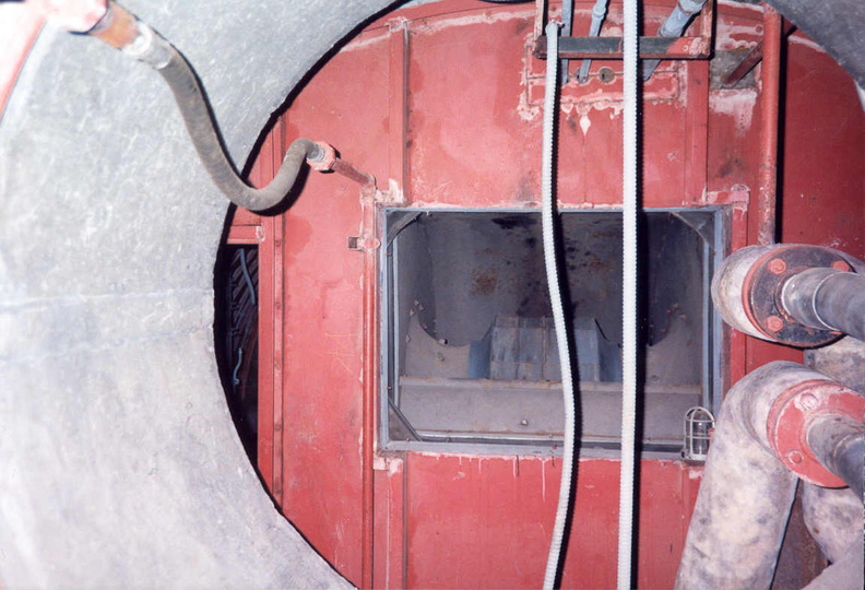 Launcher Air Filtration Facility at Lowry 724-C showing the outlet duct of the centrifugal fan that supplied air to the launcher tunnels. Airflow was toward the viewing angle of this photo. It is likely the gap between the fan and tunnel visible here was once bridged by ductwork that was removed during salvage. Taken: Circa 2002 Source: Myself blower-7-lafa.jpg