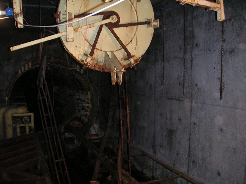 Blast lock #2, Lowry 724-C showing the emergency escape hatch hanging open and its lever and release mechanism. The tunnel in the background leads to blast lock #1 and launchers 2 and 3. Taken: August 3, 2005 Source: Myself pict0090.jpg