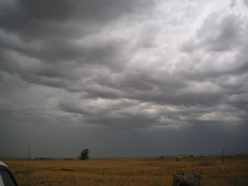 Stormy skies over Lowry 724-C. Taken near the entry portal looking northwest. Launcher #1 is on the right and shafts leading to the fuel terminal and launcher air filtration facility can be seen. The concrete vault of the chemical waste clarifier is visible at left near the vehicle. Taken: August 3, 2005. Source: Myself pict0100.jpg